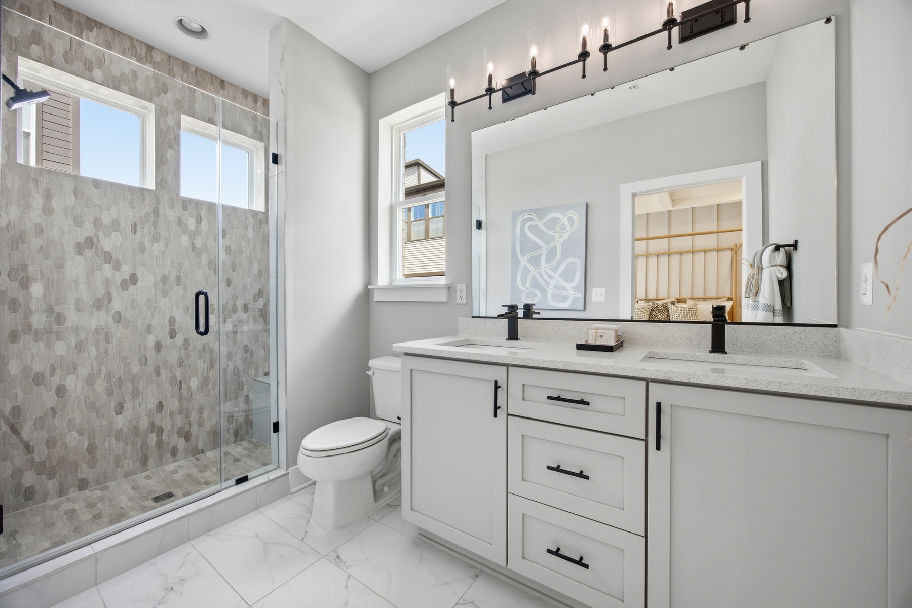Bathroom with hexagonal tile walk-in shower and matte black fixtures, real estate photography Central Maryland