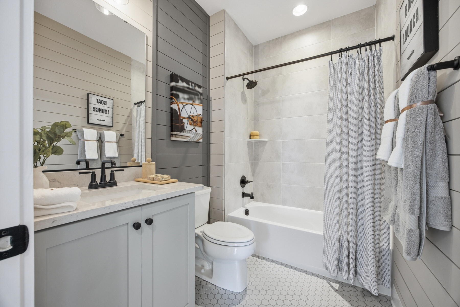 Bathroom with shiplap accent walls, walk-in shower, and bathtub, real estate photography Baltimore MD
