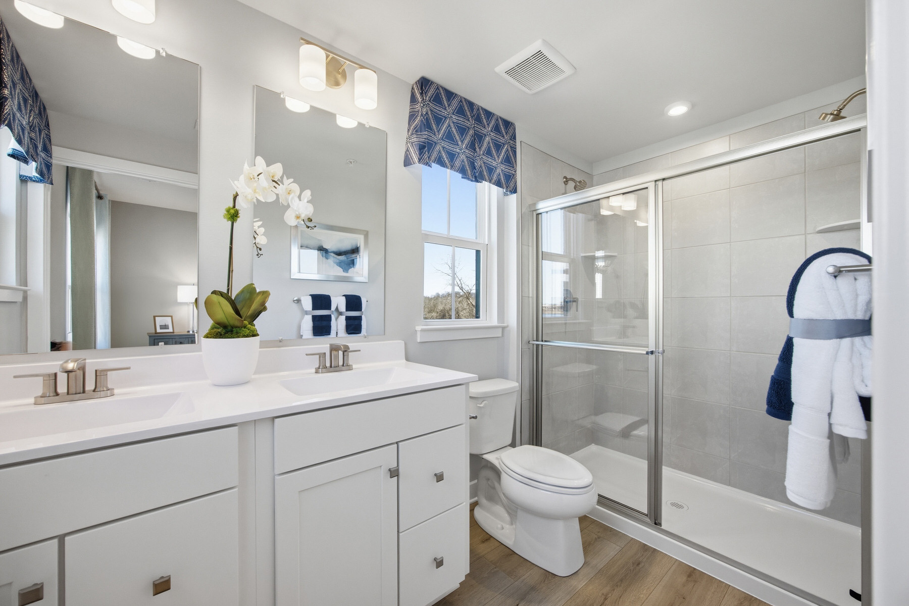 Bathroom with walk-in glass shower and white vanity, real estate photography Baltimore MD