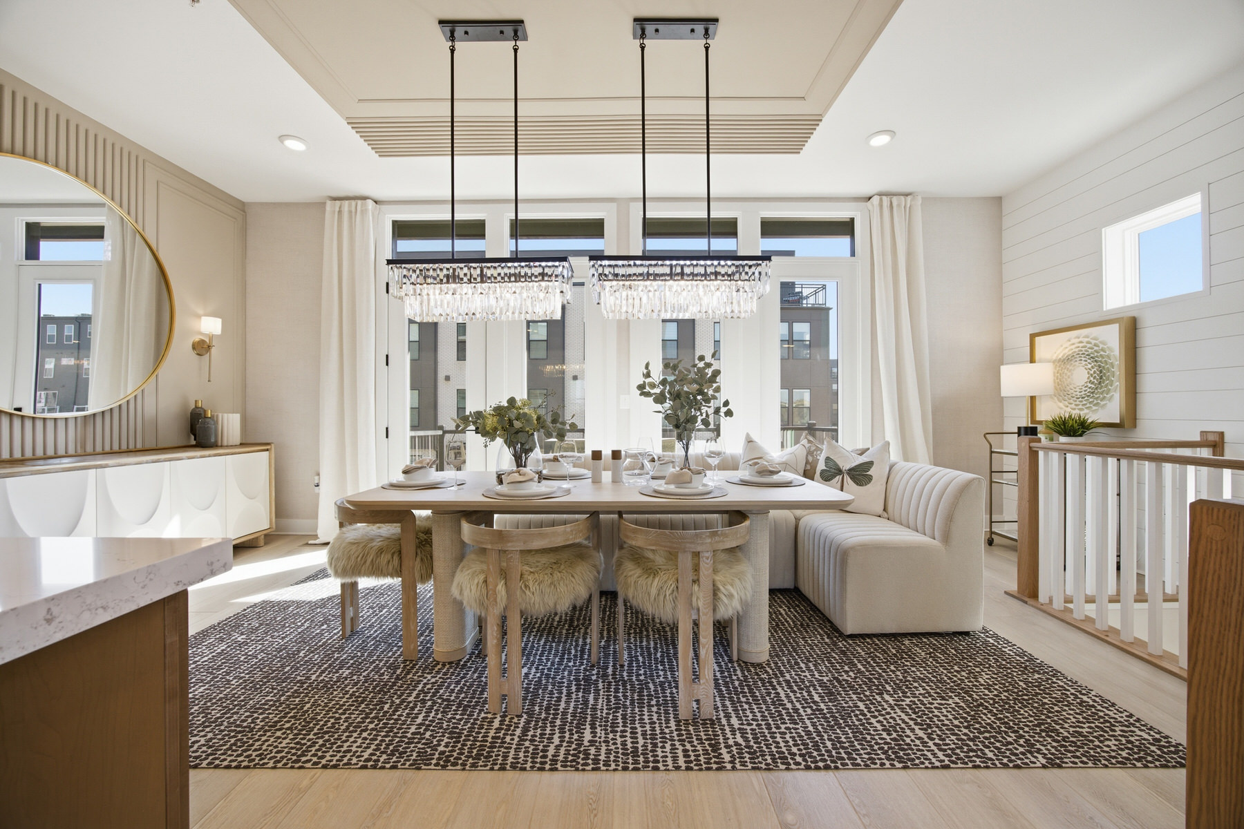 Dining room with crystal chandelier and open-plan view to kitchen, real estate photography Central Maryland