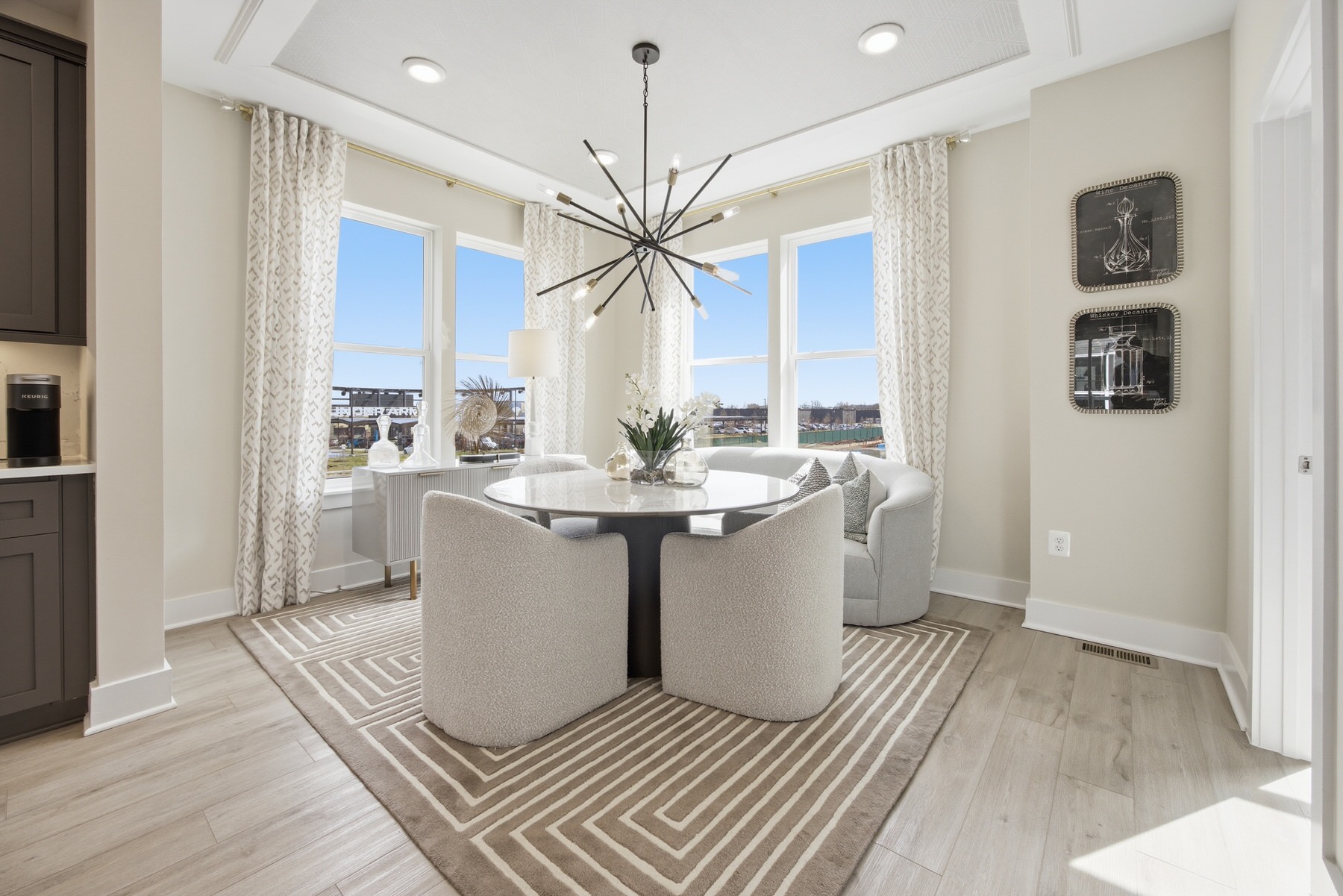 Dining room with sputnik chandelier and corner windows, real estate photography Central Maryland