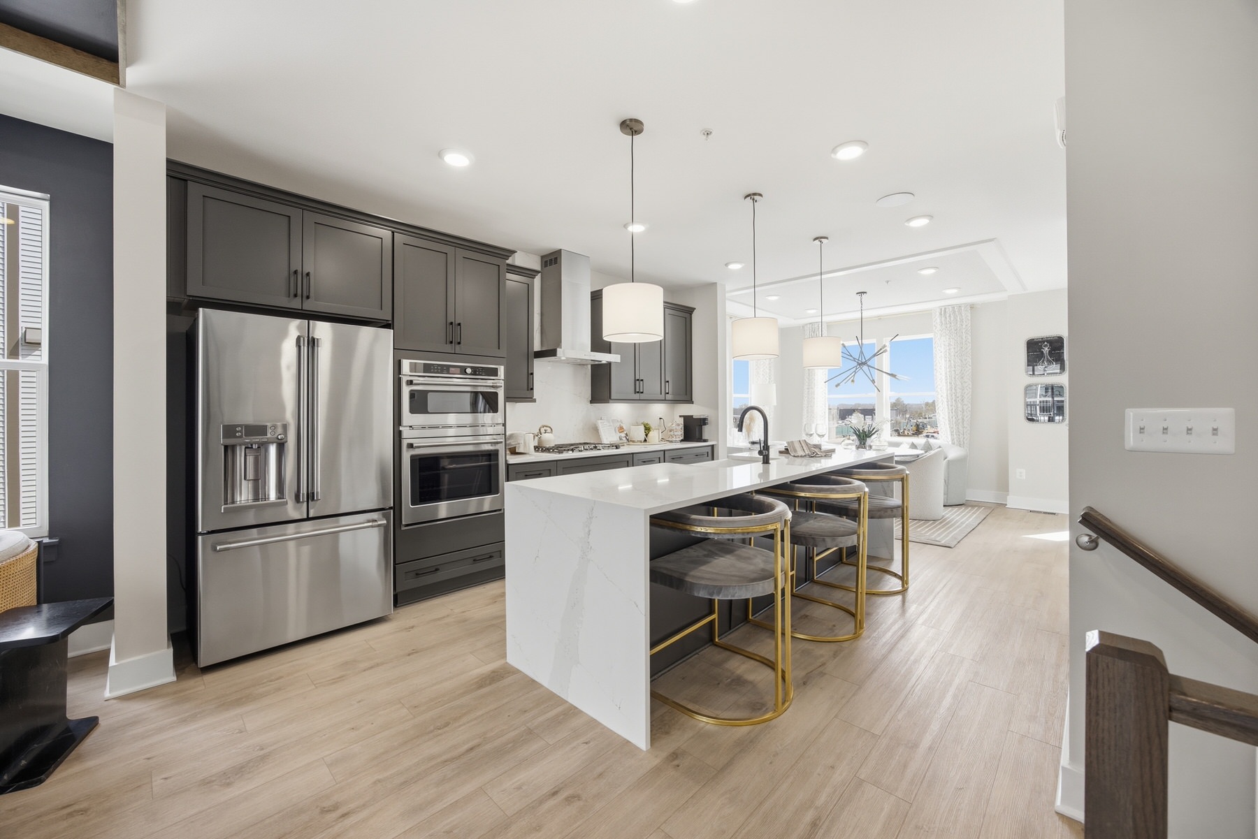 Kitchen with charcoal cabinets, waterfall island, and stainless steel appliances, real estate photography Baltimore MD