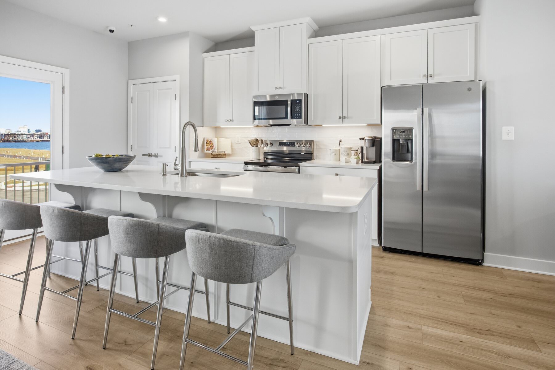 Open kitchen with island seating and waterfront views, real estate photography Baltimore MD