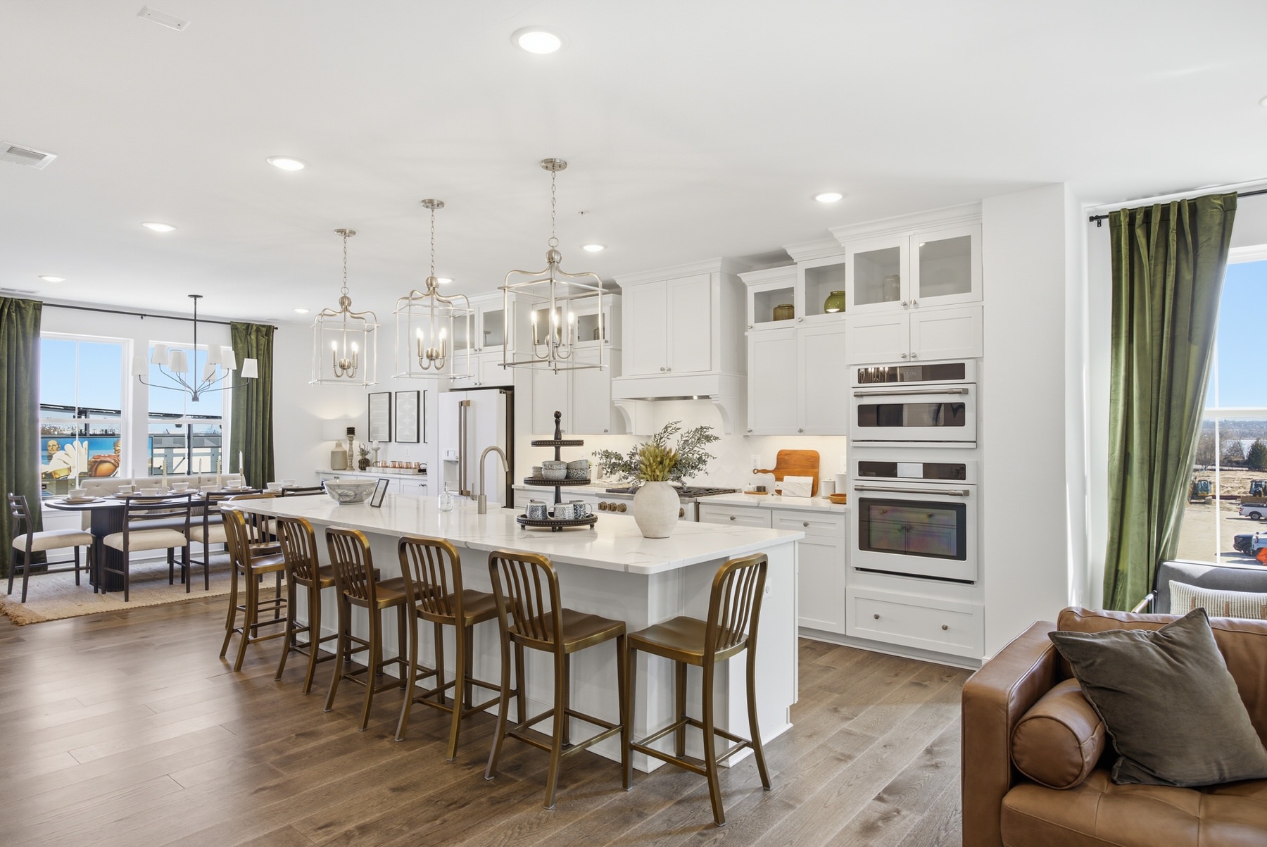 Large kitchen with white cabinets, oversized island with barstools, and views, real estate photography Baltimore MD