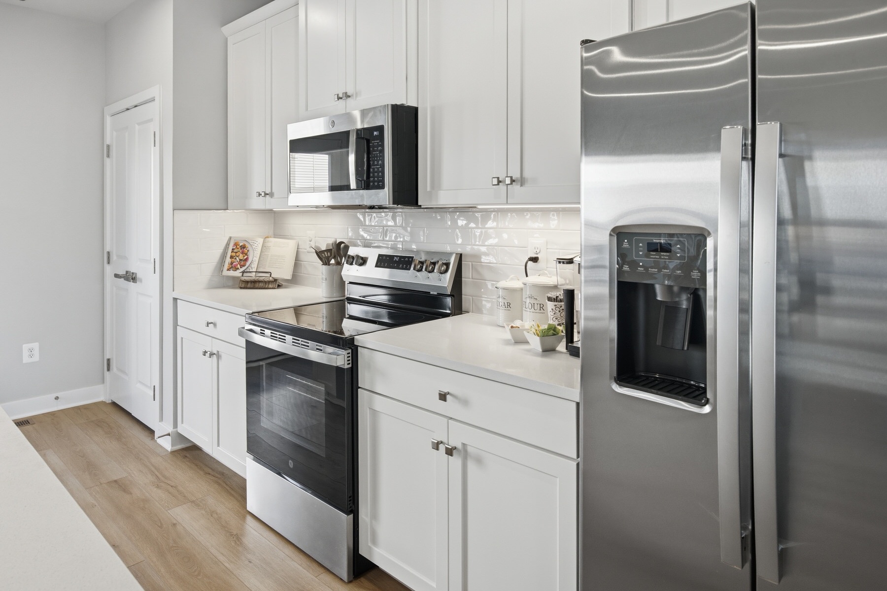 White kitchen with stainless steel appliances, professional real estate photography Baltimore MD