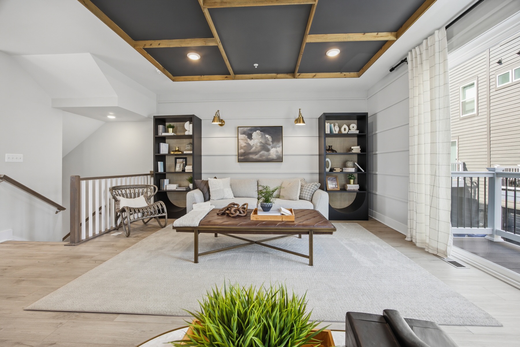 Living room with coffered ceiling and sliding glass door to deck, real estate photography Central Maryland