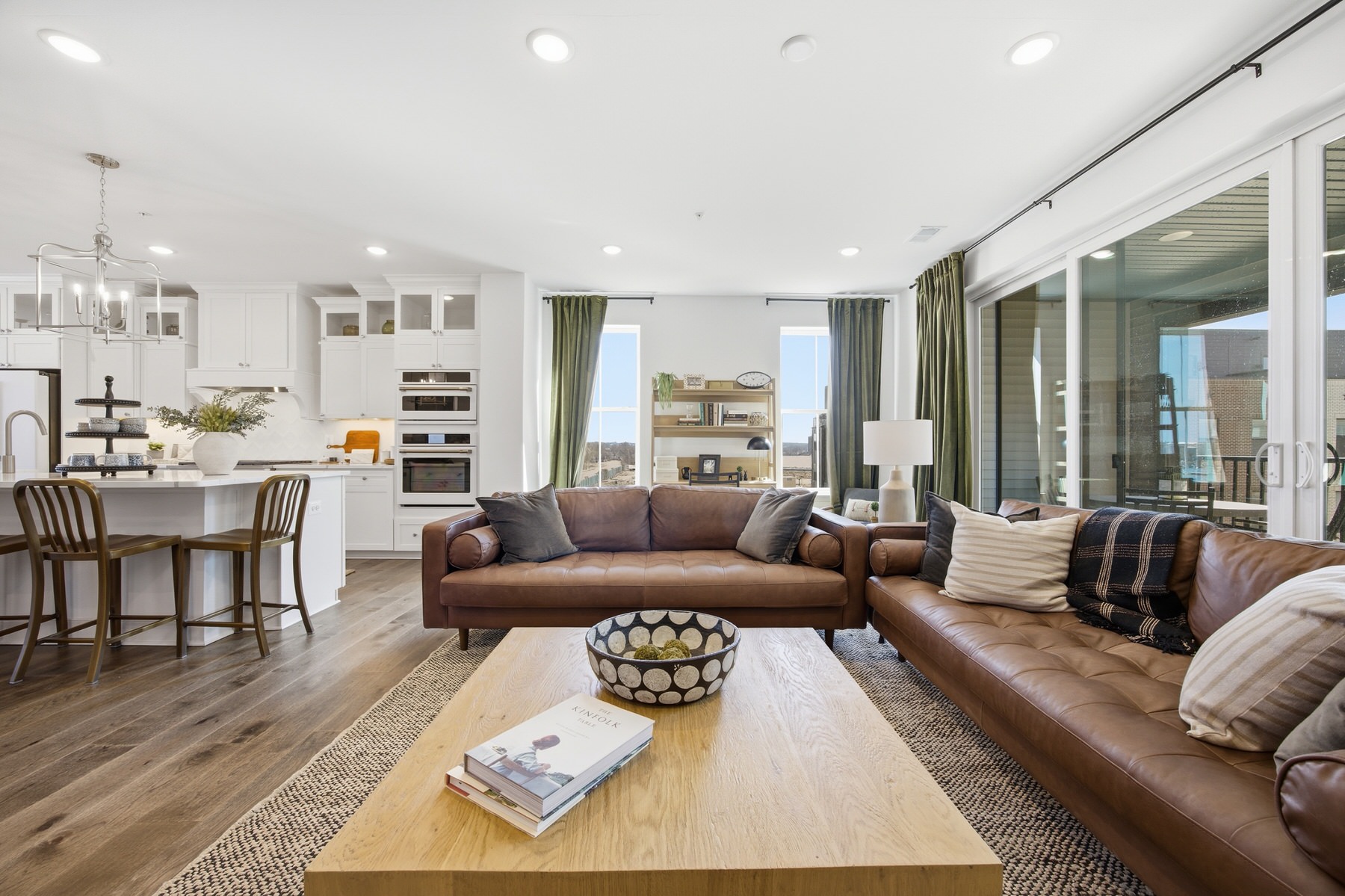 Living room with leather sectional sofa, open plan, and sweeping views, real estate photography Central Maryland