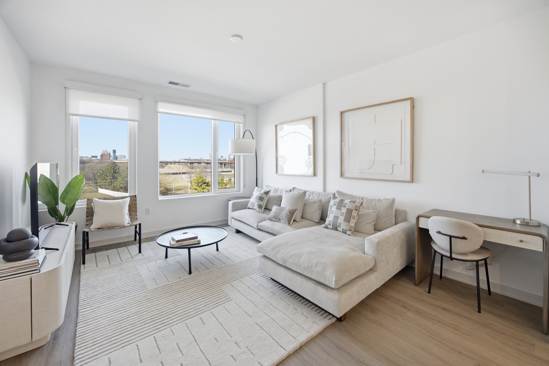 Modern living room with floor-to-ceiling windows and city views, real estate photography Baltimore MD