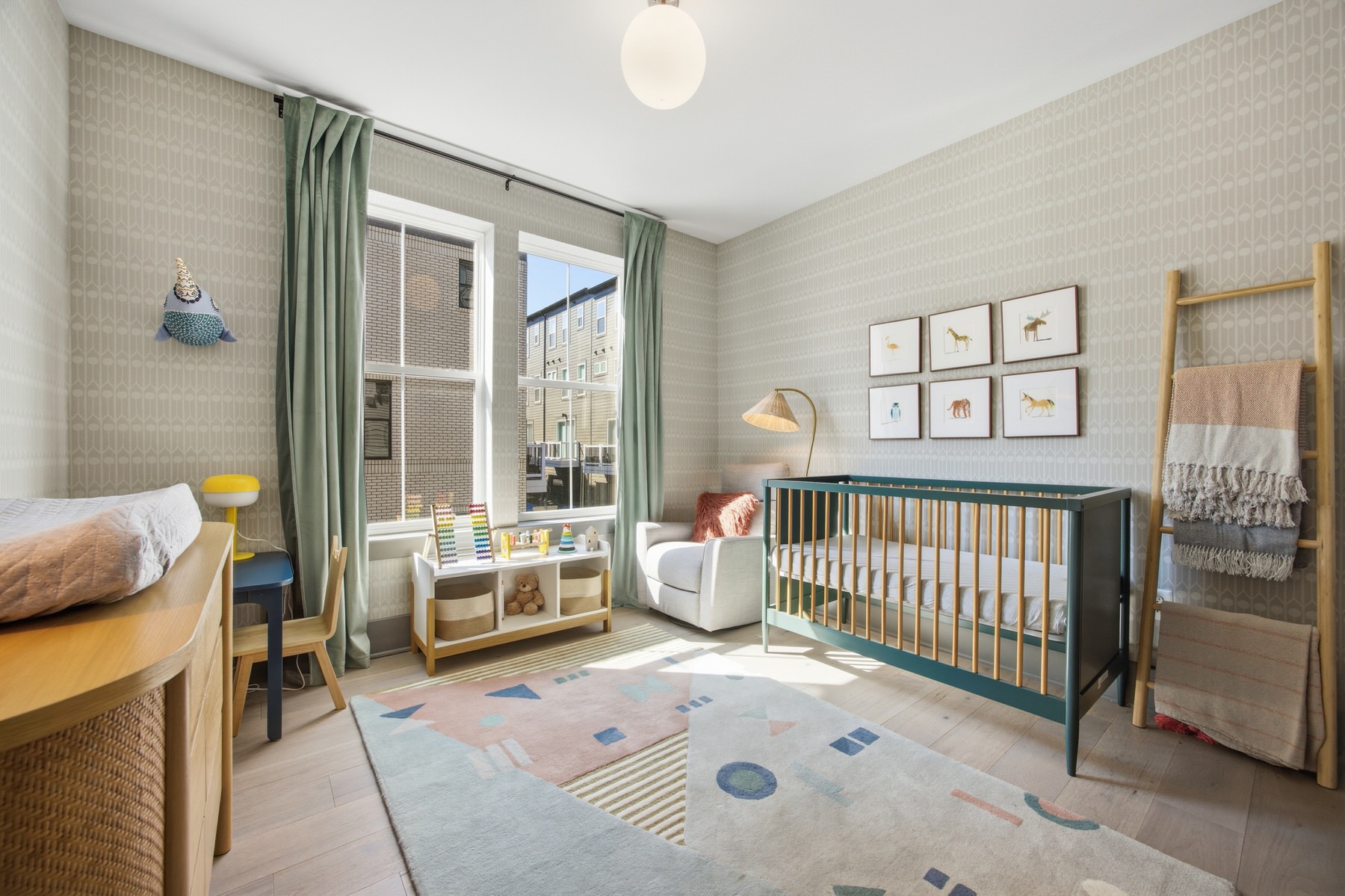 Nursery with crib and colorful decor, abundant natural light, real estate photography Baltimore MD