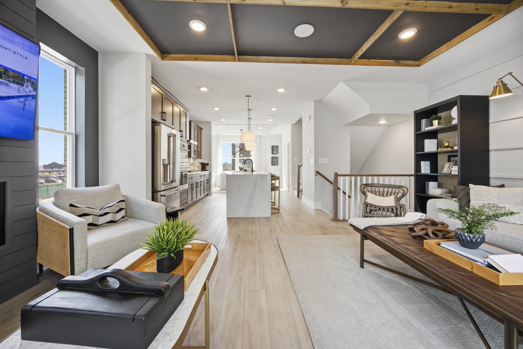 Open-plan great room with coffered ceiling and kitchen view, real estate photography Baltimore MD