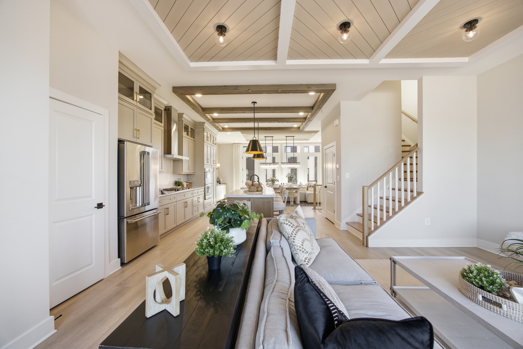 Open-plan great room with shiplap ceiling and staircase, real estate photography Baltimore MD