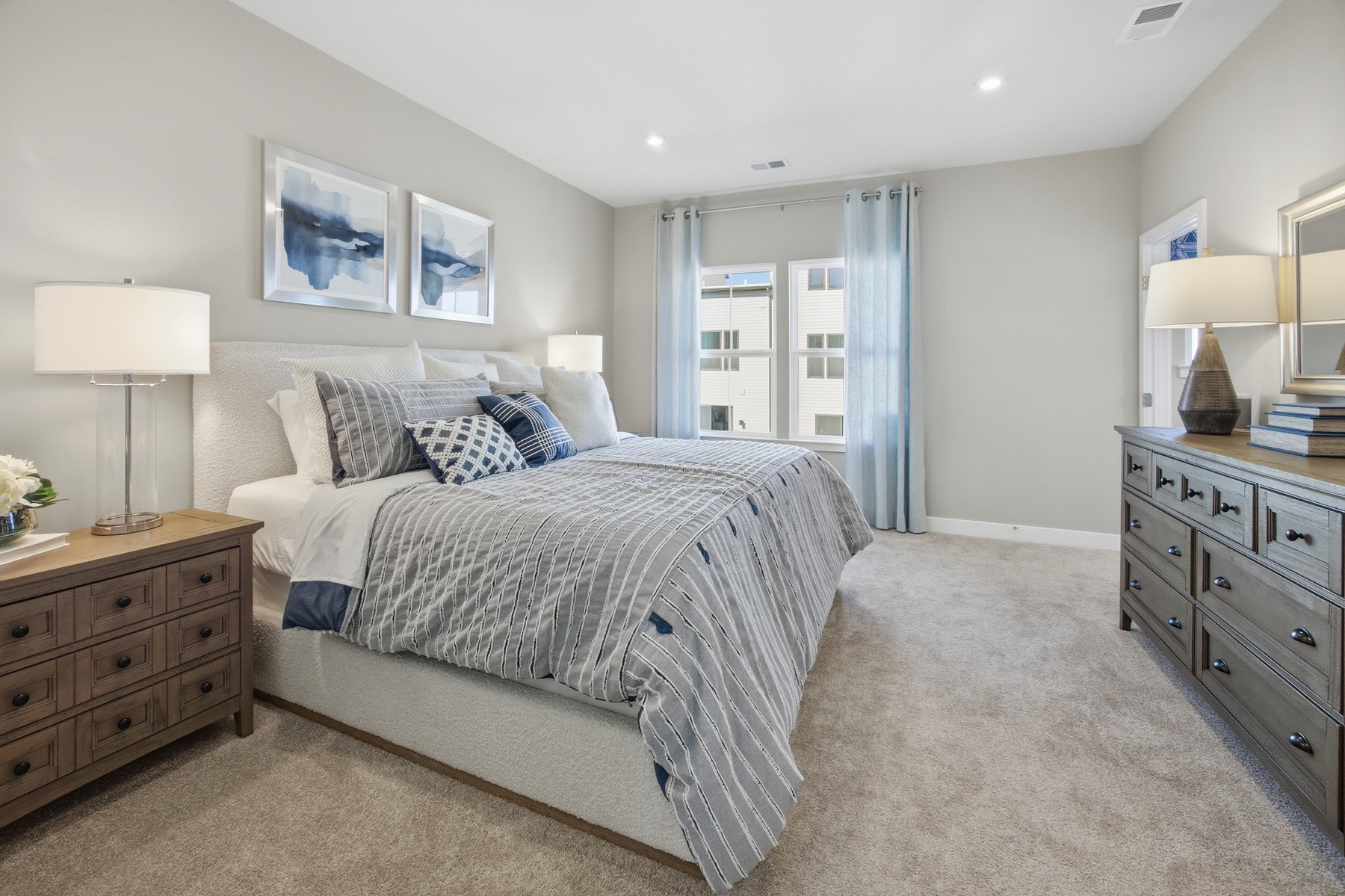 Staged primary bedroom with blue accent decor, real estate photography Central Maryland