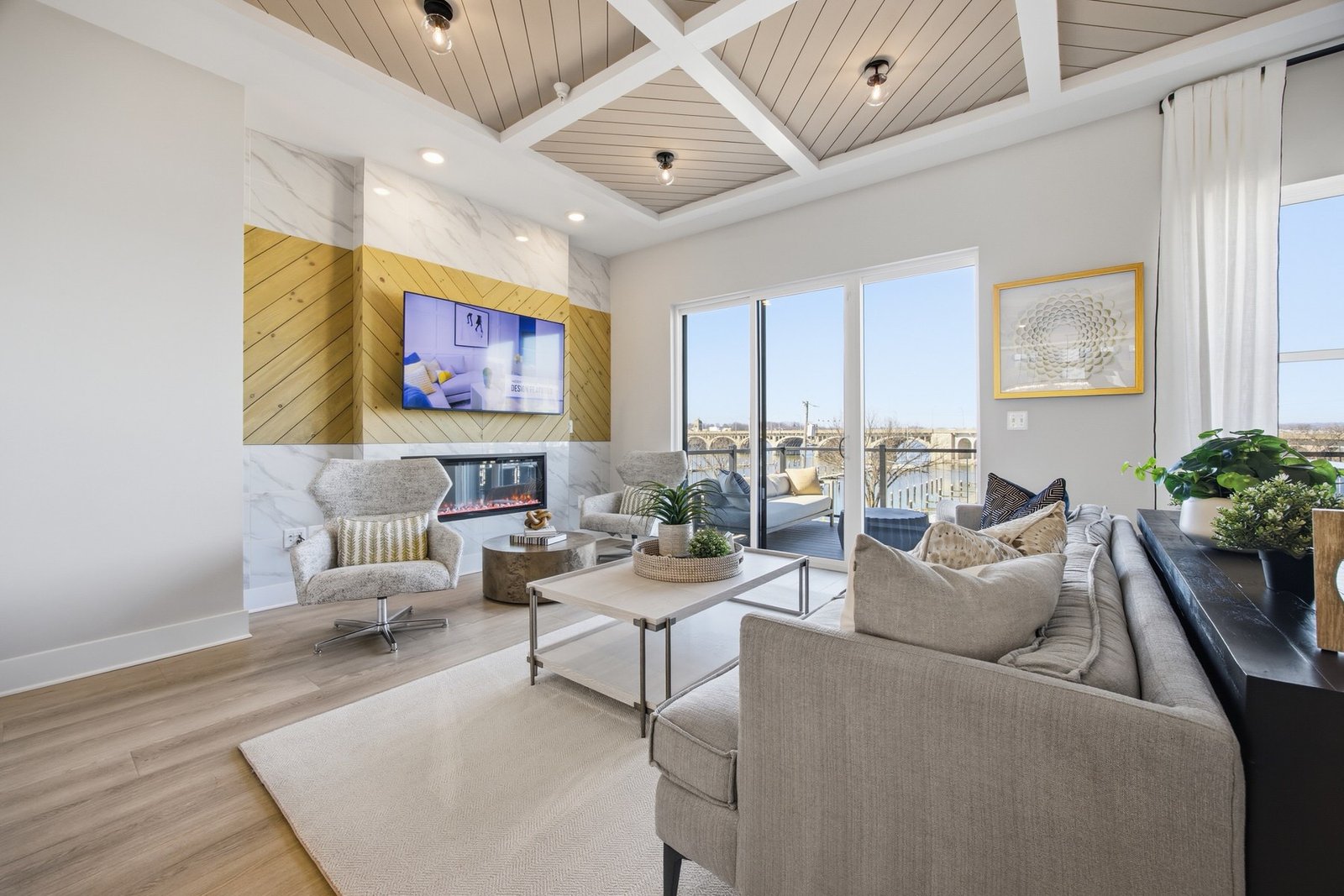 Bright living room with a coffered ceiling and waterfront view, a real estate listing photo shot in Baltimore